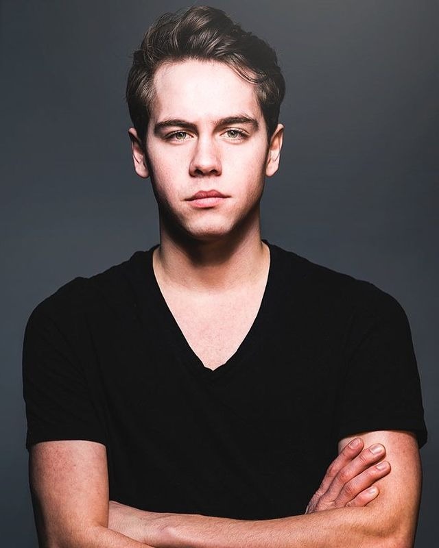 Munro Chambers posing by wearing black vest.